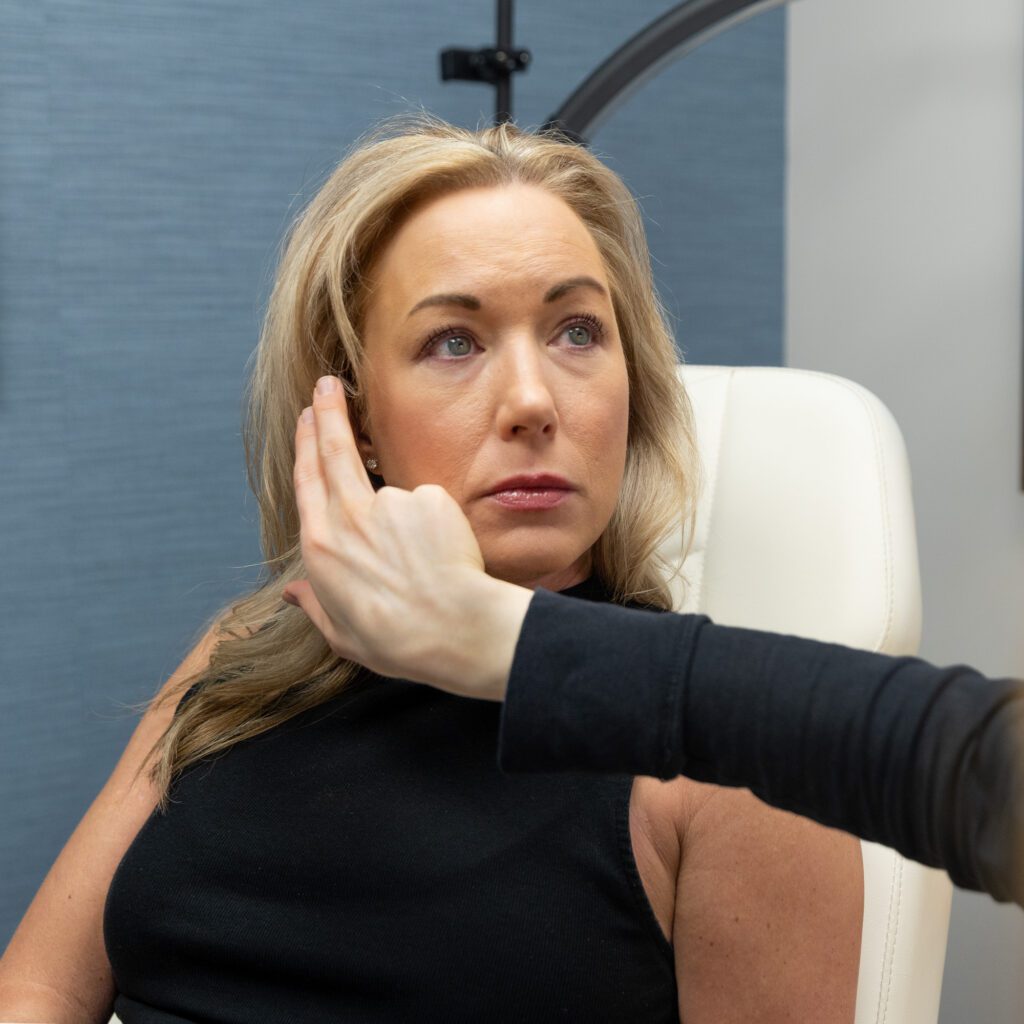 Professional consultation between client and expert reviewing treatment options.