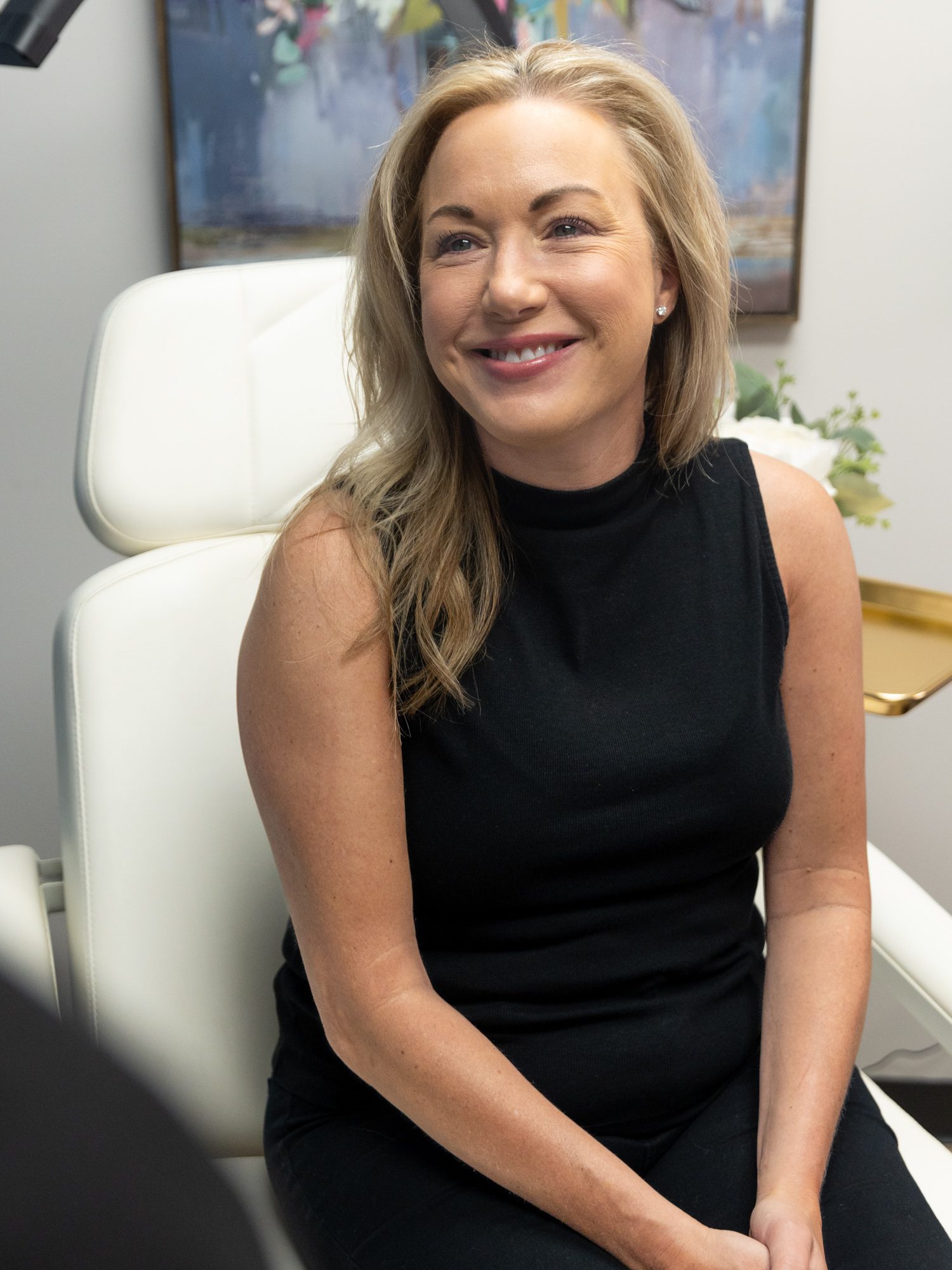 Smiling woman sitting in clinic chair