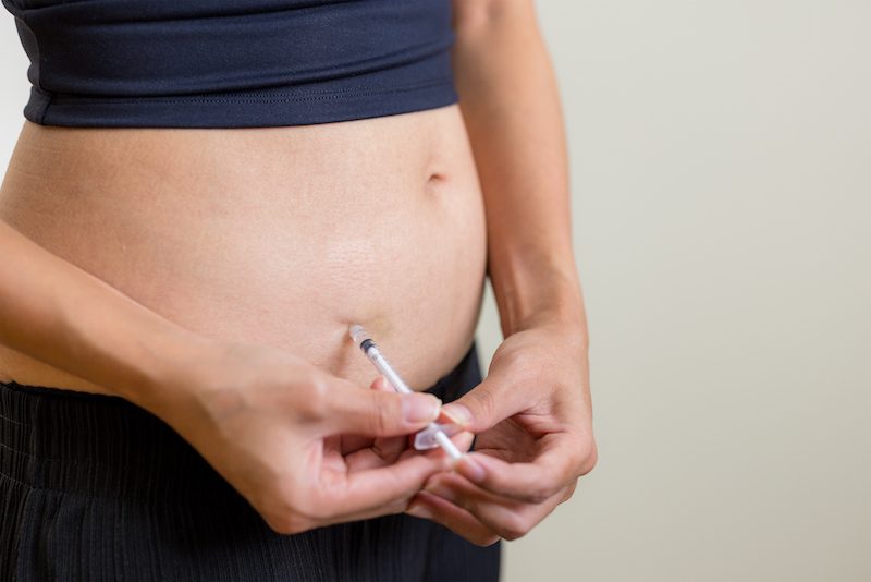 Woman self-administering Semaglutide injection in the abdomen under medical supervision at Xanadu Med Spa.
